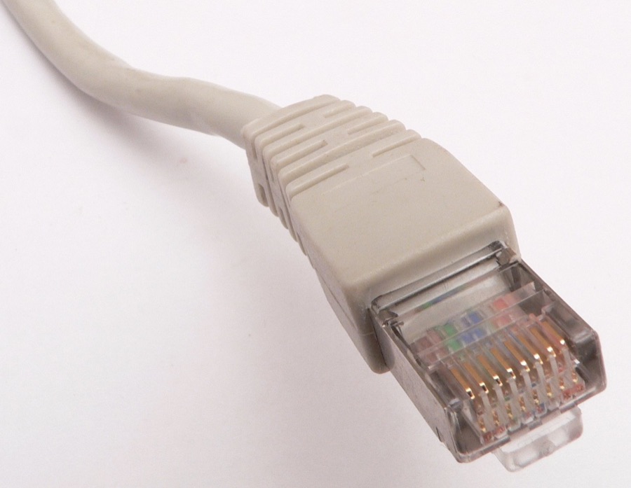 Photo of an Ethernet RJ45-style 8P8C connector with latch and contacts