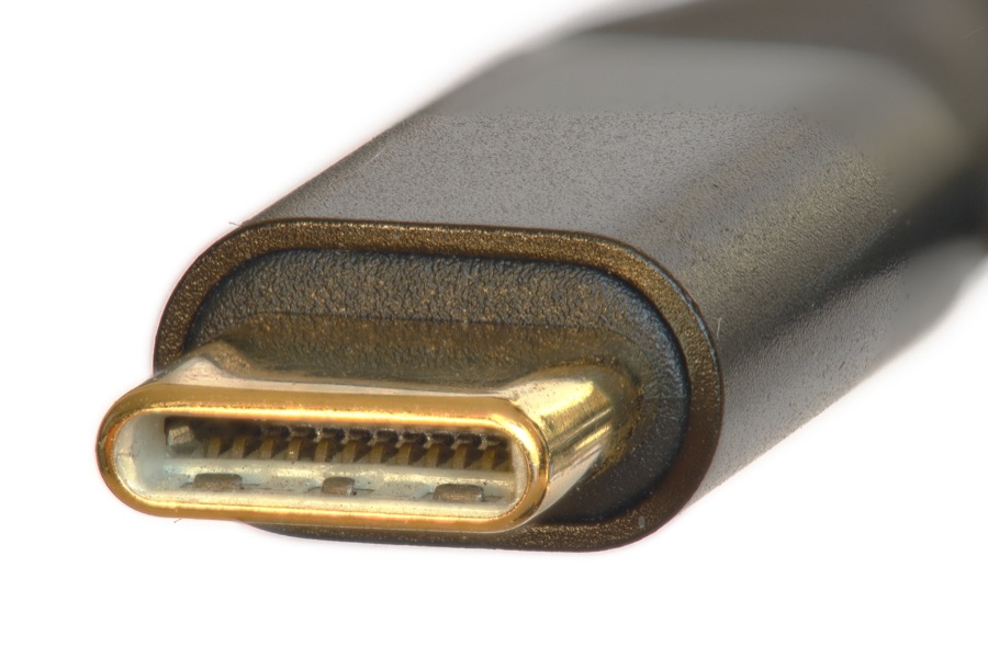 Straight-on close-up of a USB Type-C plug and its symmetrical connector opening